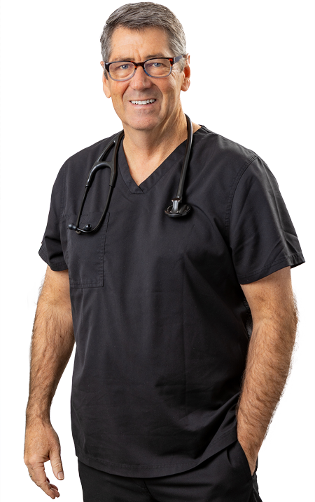 Dr. Michael Rafferty standing with one hand in pocket and smiling