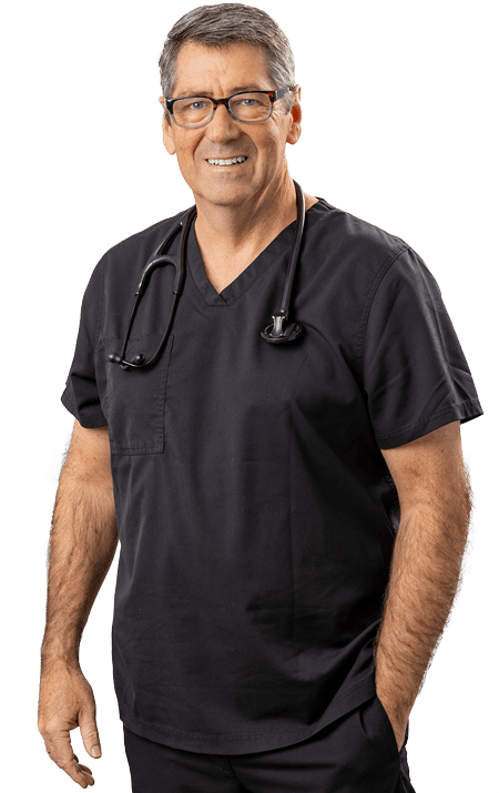 Dr. Michael Rafferty standing with one hand in pocket and smiling