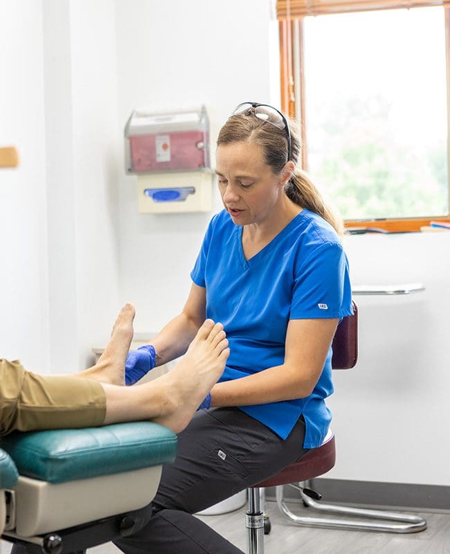 Dr. Ryder performs an exam on a patients feet