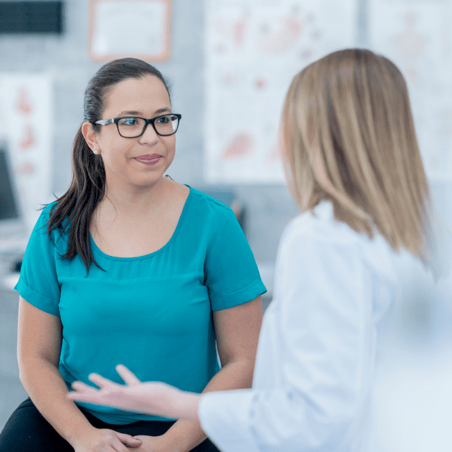 Doctor talking to female patient about interventional pain treatments