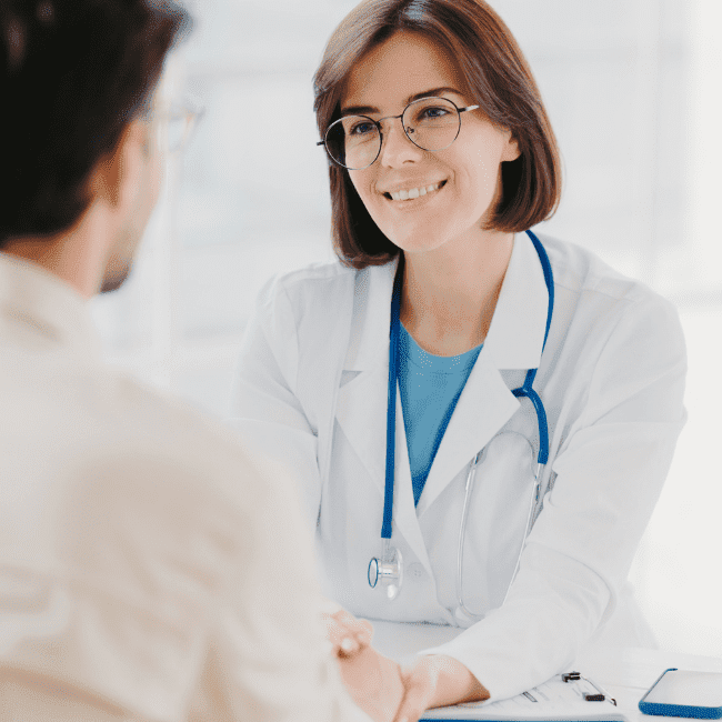 Female doctor talking to an adult patient about internal medicine treatments