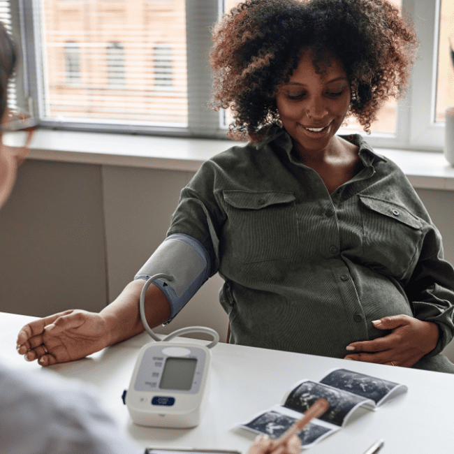 Pregnant woman getting her vitals taken during an OB_GYN wellness exam