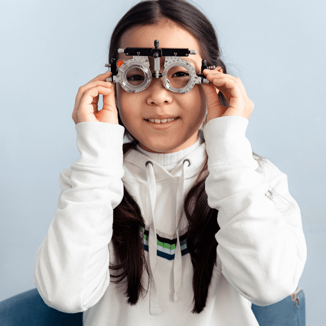 Young child getting their eyes checked by an Optometry provider